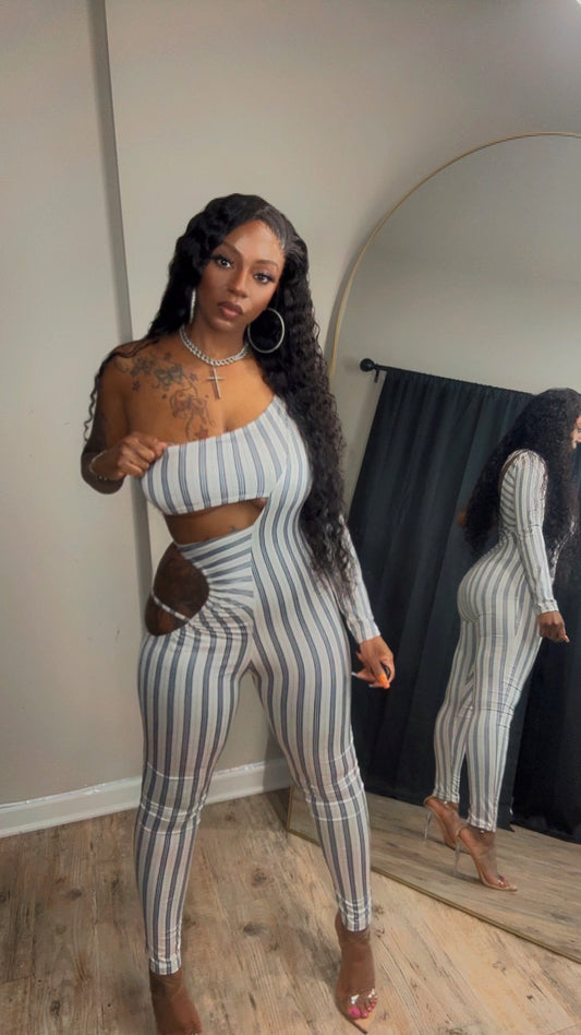 She models a beige one piece cutout bodysuit with vertical stripes.